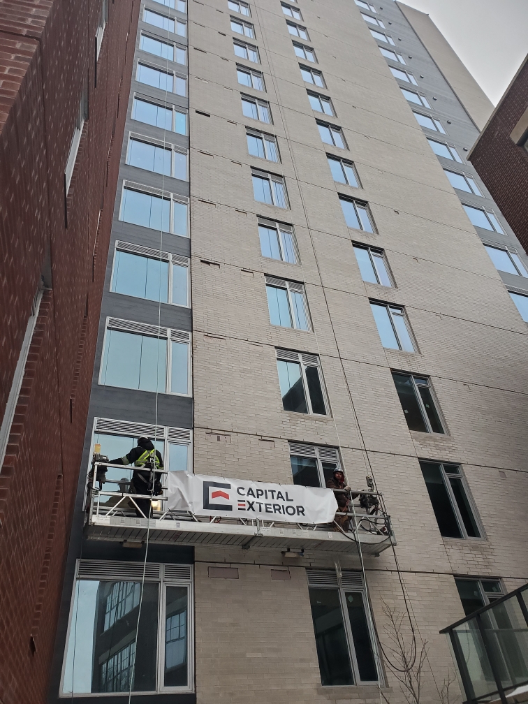 Exterior cladding installation in progress on a commercial building in Ottawa.